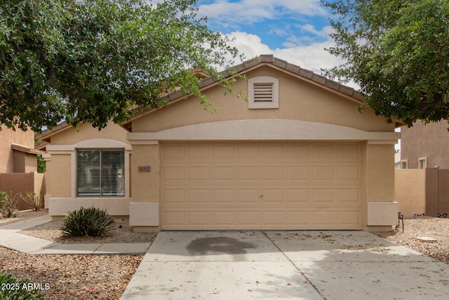 10317 E Kiva Cir, Mesa, AZ 85209 - view of front of house with an attached garage, concrete driveway, stucco siding, and fence
