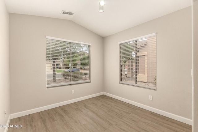 10317 E Kiva Cir, Mesa, AZ 85209 - spare room with lofted ceiling, visible vents, baseboards, and wood finished floors
