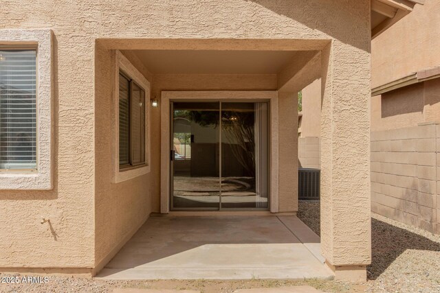 10317 E Kiva Cir, Mesa, AZ 85209 - view of exterior entry with central air condition unit and stucco siding