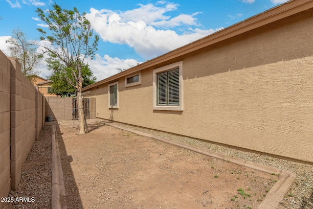 10317 E Kiva Cir, Mesa, AZ 85209 - view of side of home featuring fence private yard and stucco siding