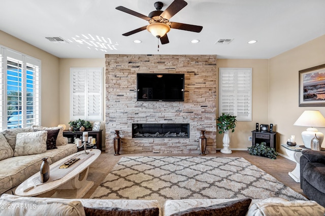 living room featuring ceiling fan and a fireplace