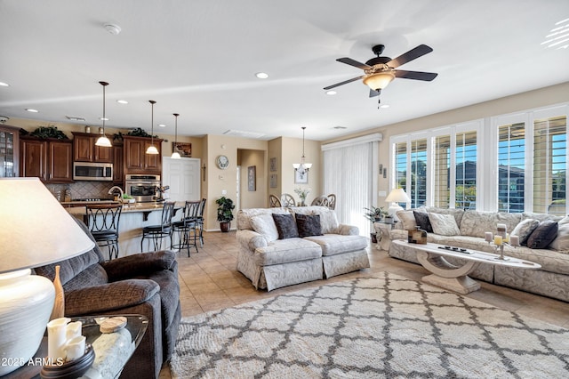 living room with light tile patterned floors and ceiling fan