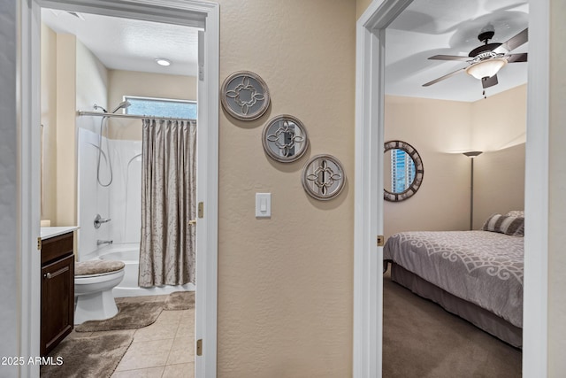 bathroom featuring tile patterned floors, ceiling fan, toilet, shower / bathtub combination with curtain, and a textured ceiling