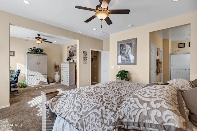 carpeted bedroom featuring ceiling fan, a spacious closet, and a closet