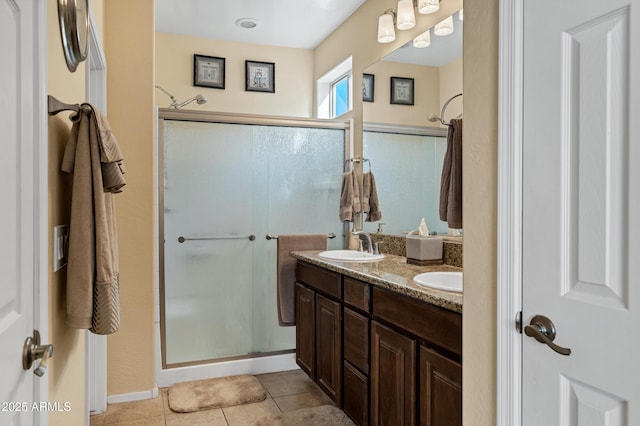 bathroom with tile patterned flooring, vanity, and an enclosed shower