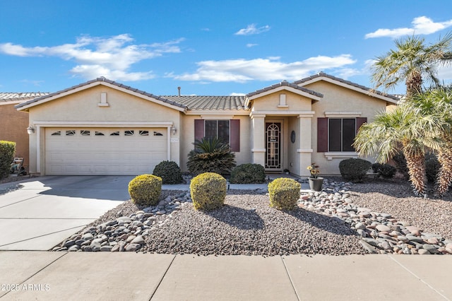 ranch-style house with driveway, a tiled roof, a garage, and stucco siding