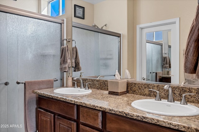 bathroom with a healthy amount of sunlight, vanity, and an enclosed shower