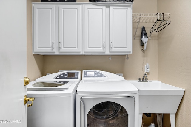 laundry room featuring cabinets, washer and dryer, and sink