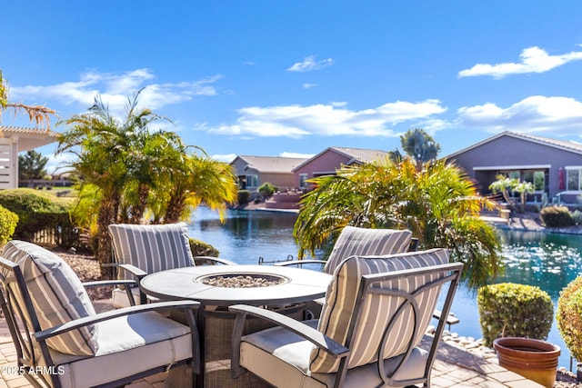 view of patio featuring a water view and an outdoor fire pit