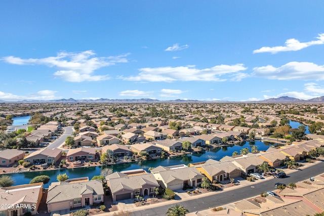 aerial view featuring a water and mountain view