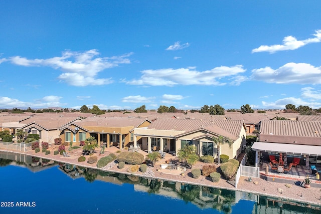 back of house with a water view and a residential view