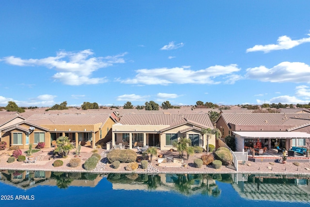 rear view of house featuring a water view and a residential view