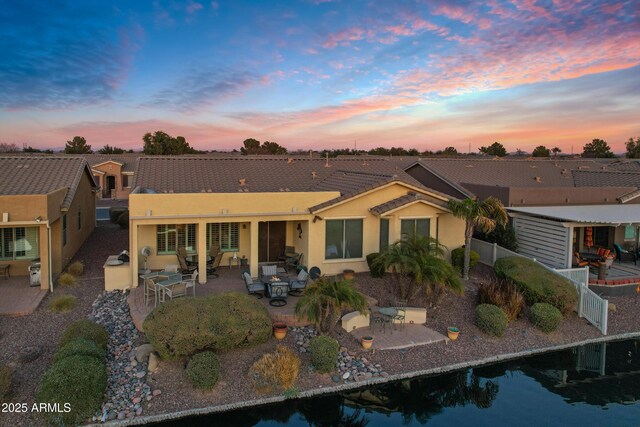 back of property featuring a patio, fence, and stucco siding