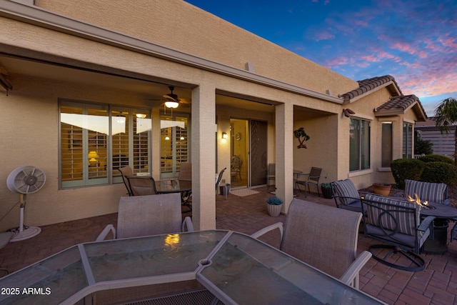 view of patio / terrace with a fire pit and outdoor dining space