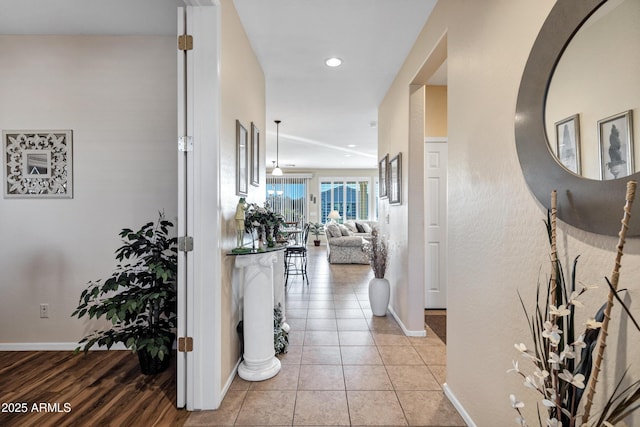 corridor featuring light tile patterned floors