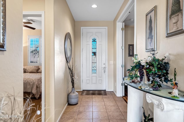 tiled entrance foyer with ceiling fan