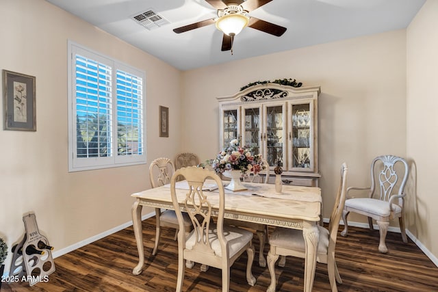 dining area featuring dark wood-type flooring and ceiling fan