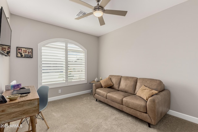 carpeted home office with visible vents, baseboards, and a ceiling fan