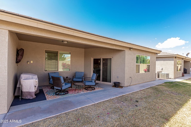 back of house featuring central air condition unit, a patio area, and stucco siding