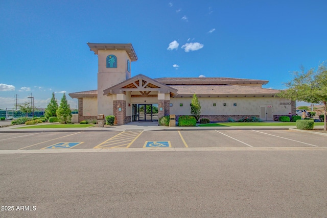 view of building exterior with uncovered parking