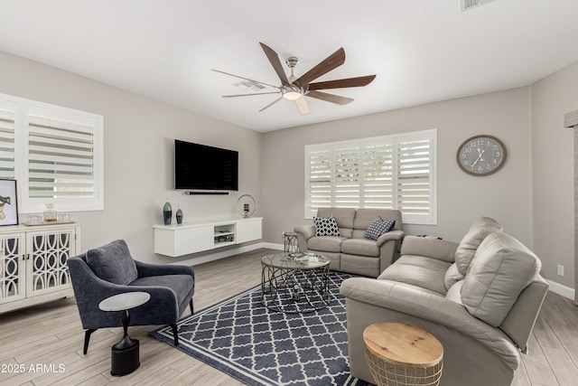 living room featuring ceiling fan, wood finished floors, and baseboards