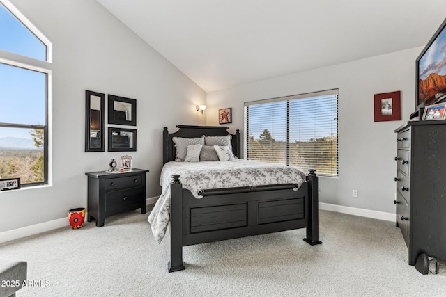 carpeted bedroom with high vaulted ceiling