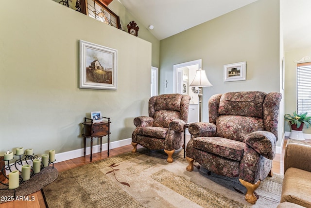 sitting room featuring hardwood / wood-style floors and high vaulted ceiling