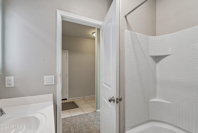 bathroom with shower / washtub combination, sink, and tile patterned floors