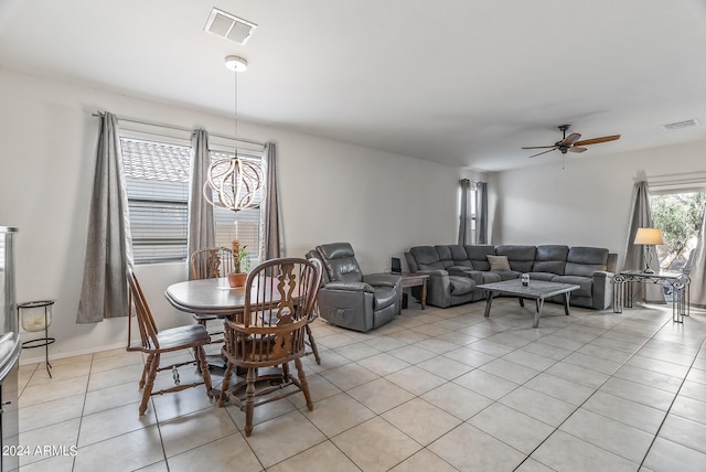 dining space with light tile patterned floors and ceiling fan