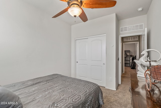 carpeted bedroom featuring ceiling fan and a closet