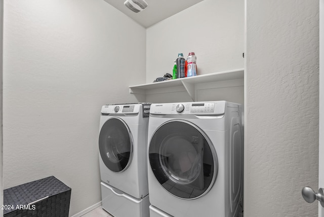 clothes washing area with washer and clothes dryer