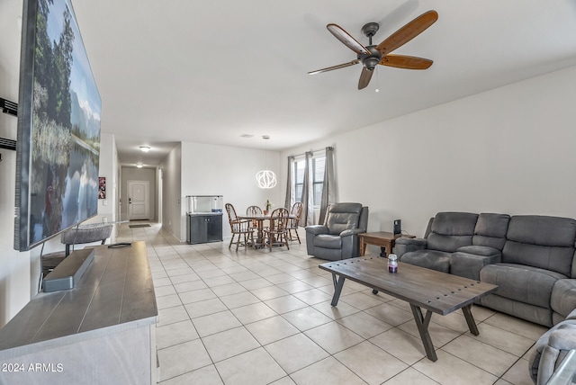 tiled living room with ceiling fan