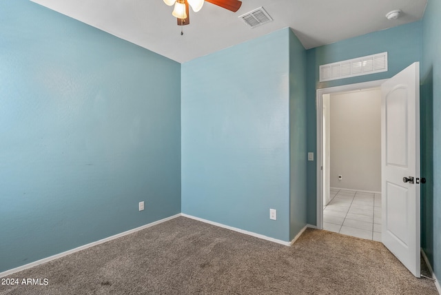 spare room with carpet and ceiling fan