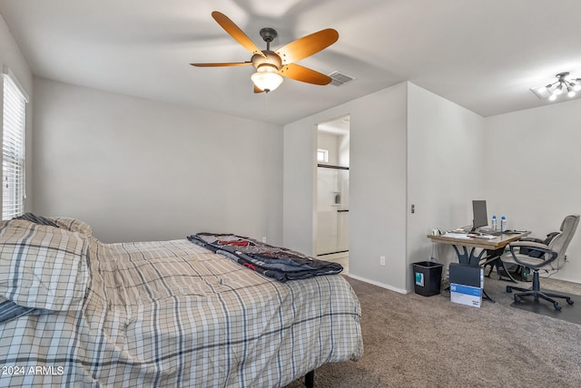 bedroom with carpet floors, ceiling fan, and ensuite bathroom