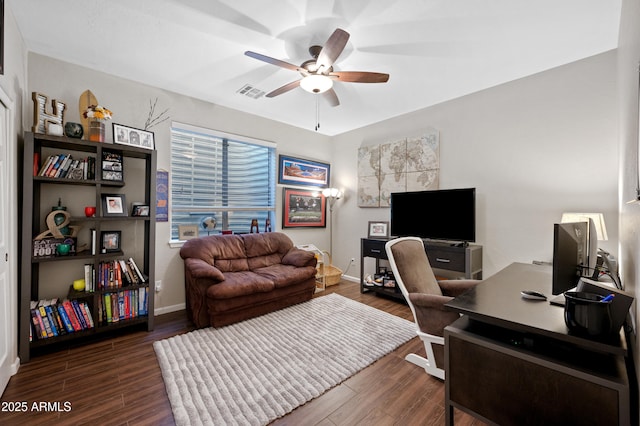 office area featuring visible vents, baseboards, dark wood-type flooring, and a ceiling fan