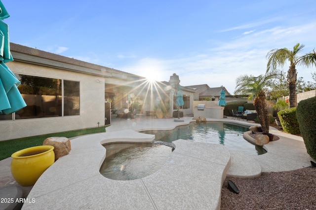 view of pool with a patio, fence, a fenced in pool, and an outdoor kitchen