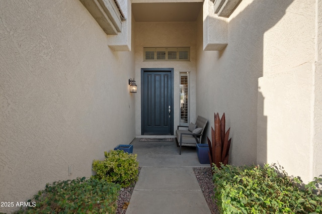 property entrance with stucco siding