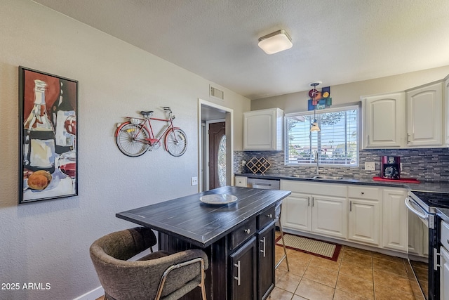 kitchen with sink, white cabinets, and appliances with stainless steel finishes