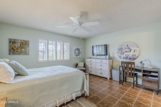 tiled bedroom with ceiling fan and a textured ceiling