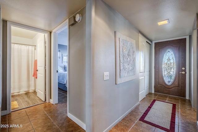 entrance foyer featuring tile patterned floors and a textured ceiling