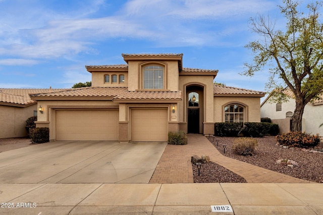 mediterranean / spanish-style home with a garage