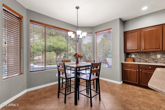 tiled dining area with an inviting chandelier