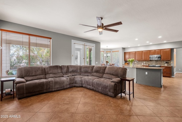 tiled living room with ceiling fan