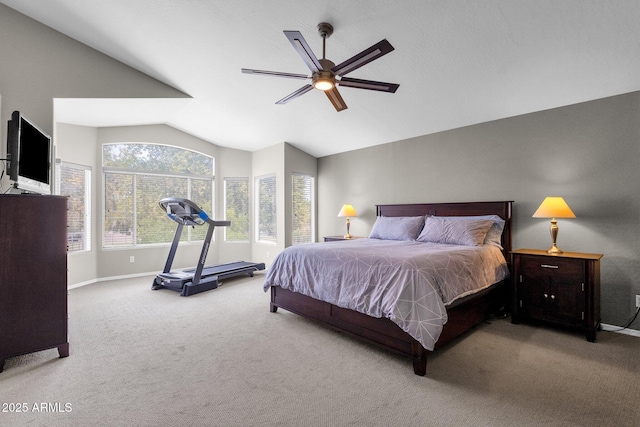 carpeted bedroom with vaulted ceiling and ceiling fan