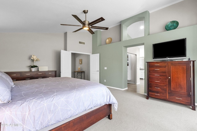 bedroom with ceiling fan, light colored carpet, and high vaulted ceiling