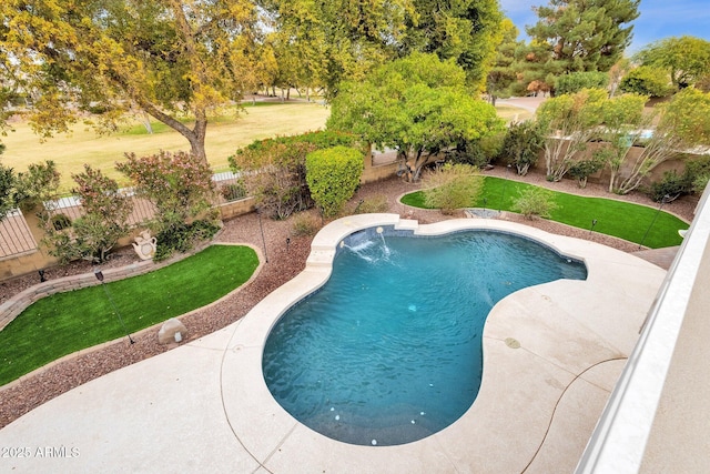 view of swimming pool featuring pool water feature and a yard