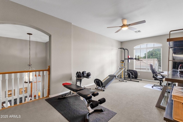 exercise room with ceiling fan and carpet floors