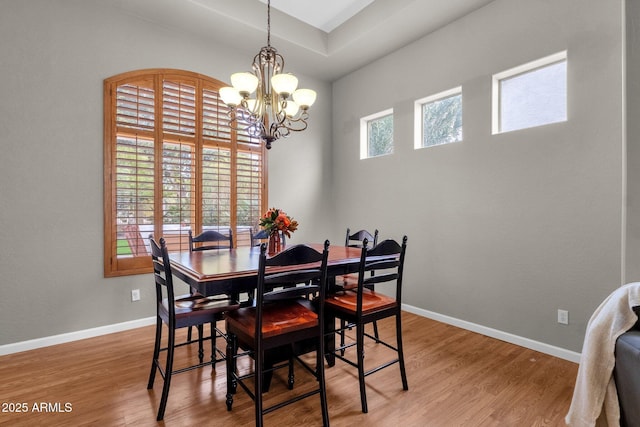 dining area featuring hardwood / wood-style floors and a notable chandelier