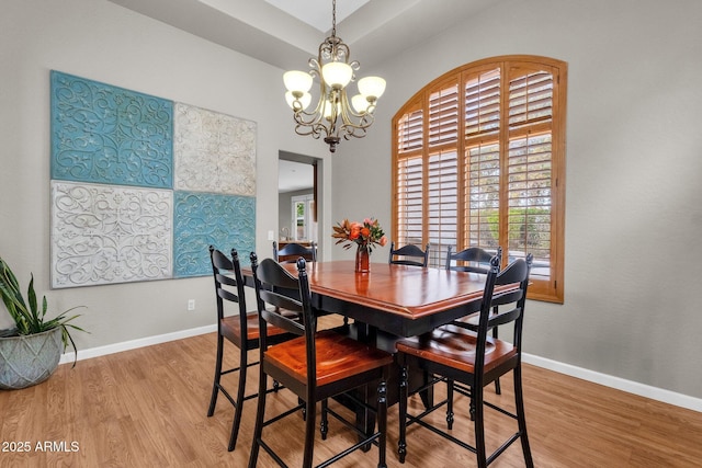 dining room featuring a notable chandelier and light hardwood / wood-style floors