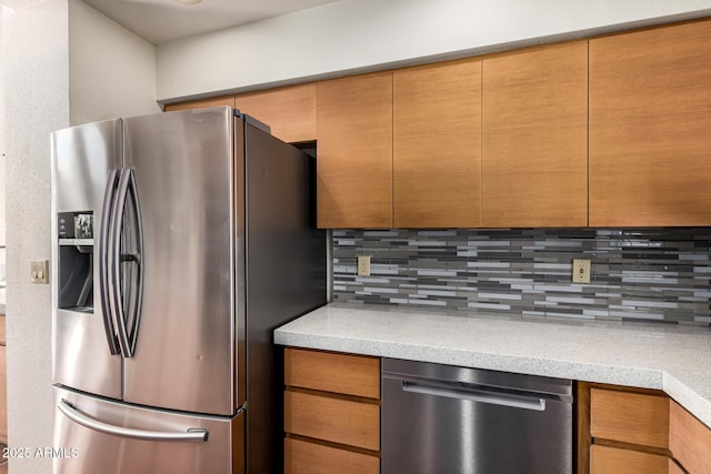 kitchen with light countertops, appliances with stainless steel finishes, and backsplash